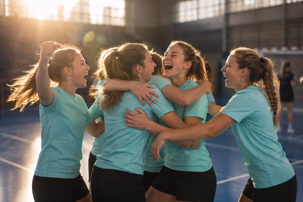 A handball team celebrating together after a match.
